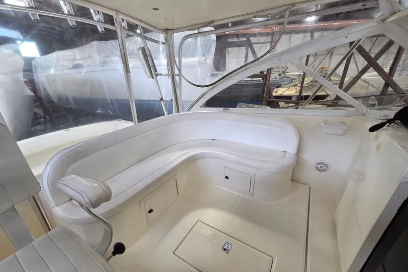 Slide: The Image of 2004 Carolina Classic 35 boat interior with white seating and enclosed cabin. - 9