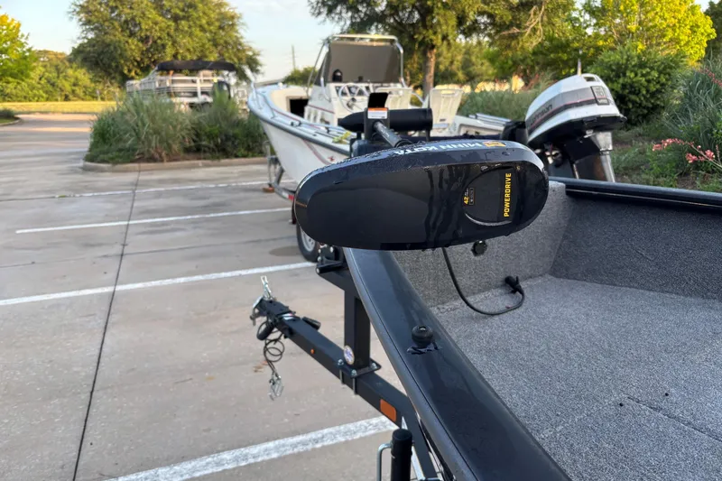 Slide: The Image of 2025 Tracker Super Guide V-16 T boat with PowerDrive motor in parking lot. - 5