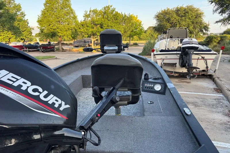 Slide: The Image of 2025 Tracker Super Guide V-16 T boat with Mercury engine in a parking lot. - 6