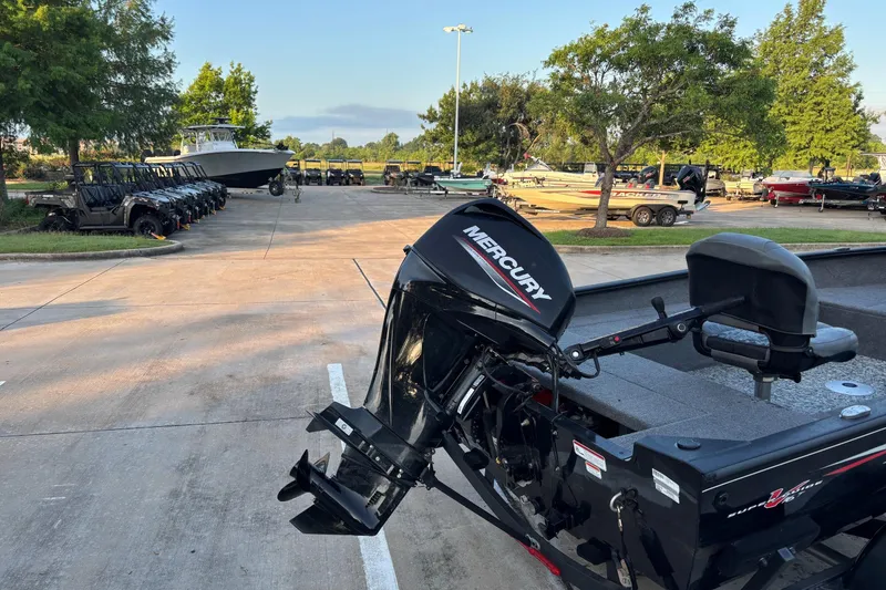 Slide: The Image of 2025 Tracker Super Guide V-16 T boat with Mercury engine in a parking lot. - 7