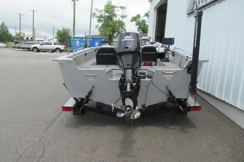 Slide: The Image of 2010 Tracker Pro Guide V-175 SC boat with Mercury 90 engine, parked outdoors. - 3