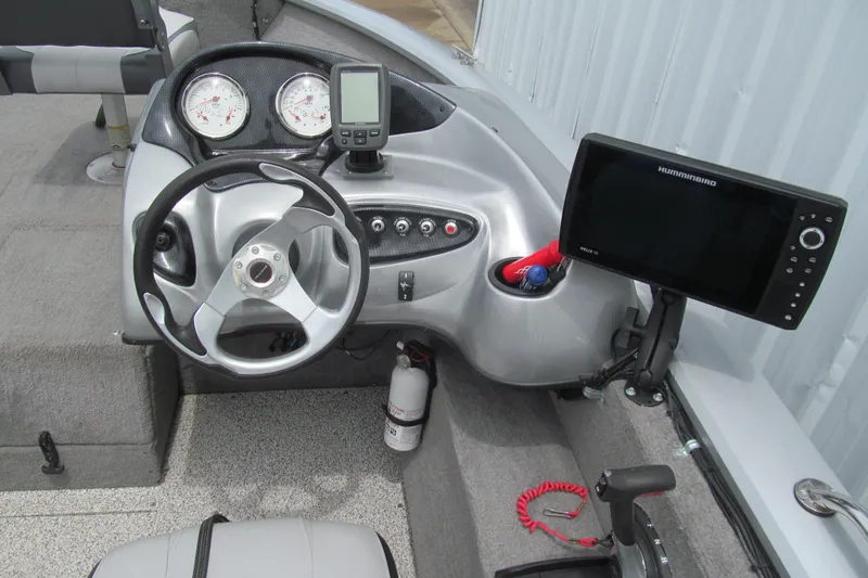 Slide: The Image of 2010 Tracker Pro Guide V-175 SC boat dashboard with steering wheel and navigation equipment. - 5