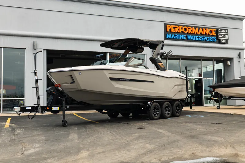 The Image of 2026 MasterCraft X24 boat on trailer outside Performance Marine Watersports store. - 1
