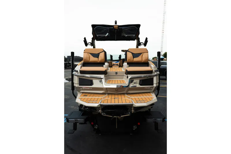 Slide: The Image of 2026 MasterCraft X24 boat with tan seating and sleek design. - 11