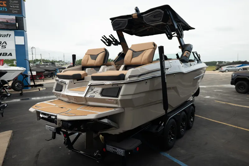 Slide: The Image of 2026 MasterCraft X24 boat on trailer, featuring sleek design and luxurious seating. - 12