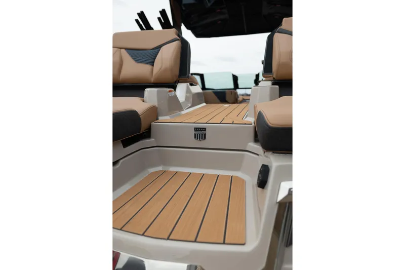 Slide: The Image of 2026 MasterCraft X24 boat interior with tan seating and teak-style flooring. - 15