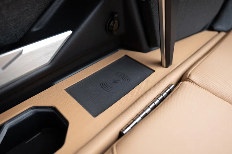Slide: The Image of Interior detail of 2026 MasterCraft X24 boat featuring wireless charging pad and cup holder. - 20
