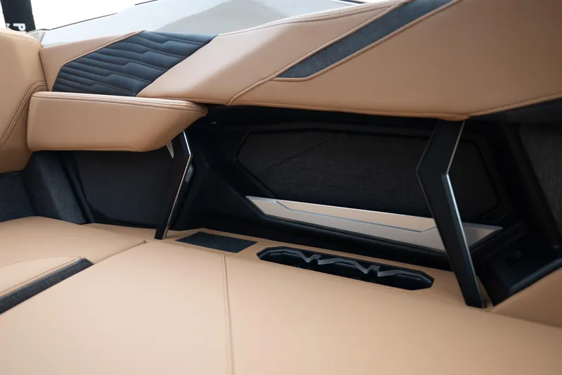 Slide: The Image of 2026 MasterCraft X24 interior with tan and black upholstery detailing. - 22