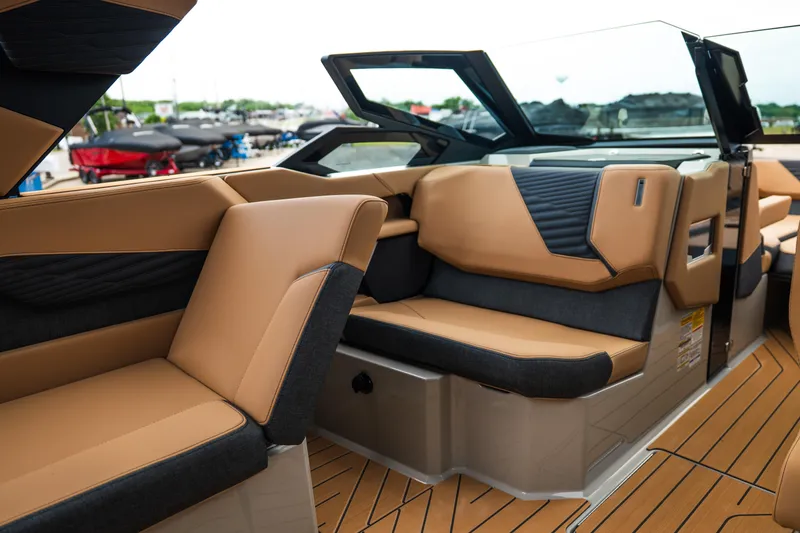 Slide: The Image of Luxurious interior of 2026 MasterCraft X24 boat with tan and black seating. - 24