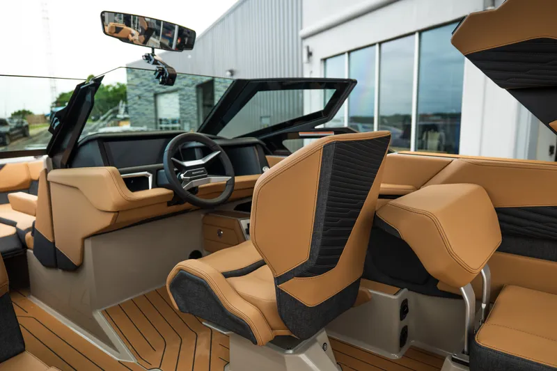 Slide: The Image of Interior of 2026 MasterCraft X24 boat with luxurious tan and black seating. - 25