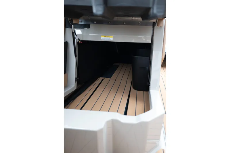 Slide: The Image of 2026 MasterCraft X24 boat interior storage compartment with sleek flooring design. - 28