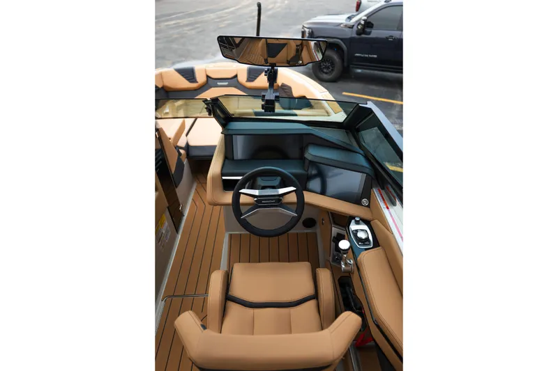 Slide: The Image of Interior view of 2026 MasterCraft X24 boat cockpit with tan seating and modern controls. - 29