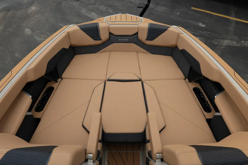 Slide: The Image of 2026 MasterCraft X24 boat interior with tan and black seating, showcasing luxury design. - 30