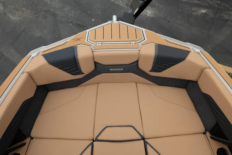 Slide: The Image of 2026 MasterCraft X24 boat interior with tan and black seating, showcasing luxury design. - 31