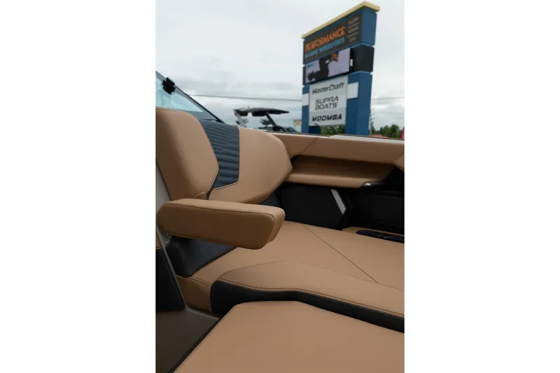 Slide: The Image of 2026 MasterCraft X24 boat interior with tan leather seating and armrest. - 34