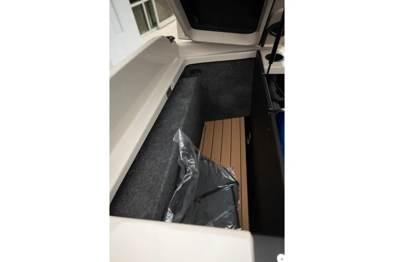 Slide: The Image of Storage compartment of 2026 MasterCraft X24 boat, featuring sleek interior design. - 45