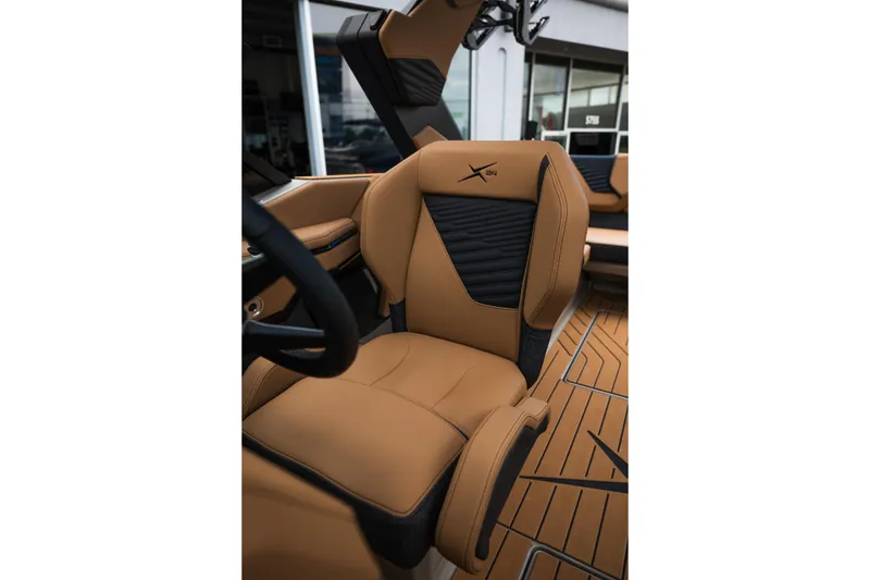 Slide: The Image of 2026 MasterCraft X24 boat interior with luxurious tan leather seating. - 48