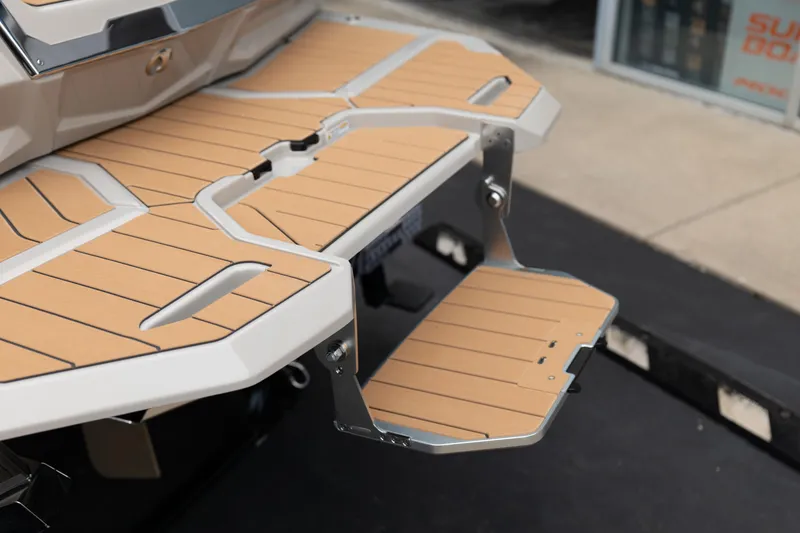 Slide: The Image of 2026 MasterCraft X24 swim platform with teak-style decking and foldable step. - 9