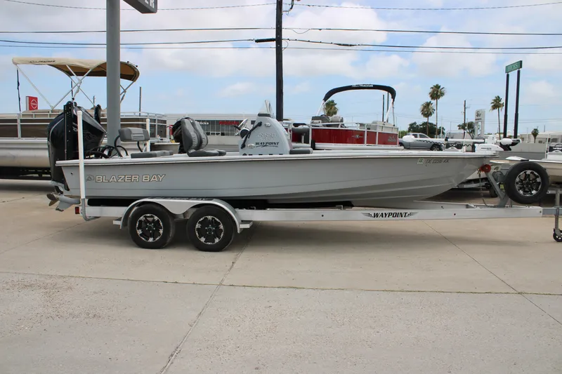Slide: The Image of 2021 Blazer Bay 2220 GTS boat on trailer, parked outdoors. - 4