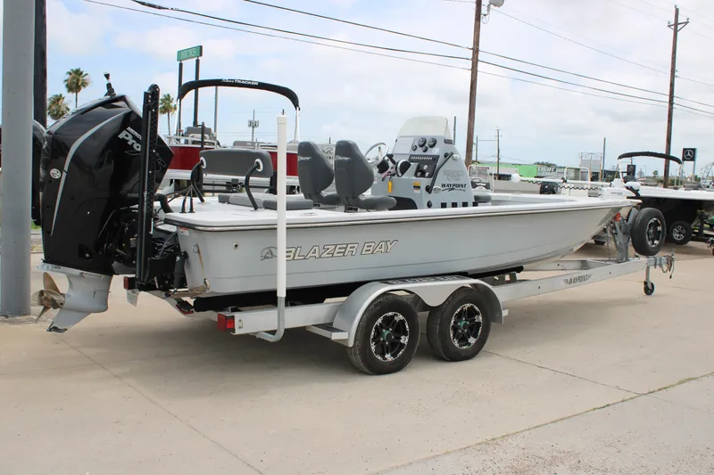 Slide: The Image of 2021 Blazer Bay 2220 GTS boat on trailer, parked outdoors. - 5