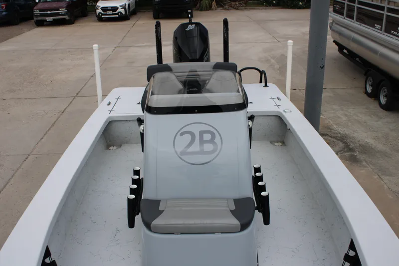 Slide: The Image of 2021 Blazer Bay 2220 GTS boat with center console and seating, parked on concrete. - 9