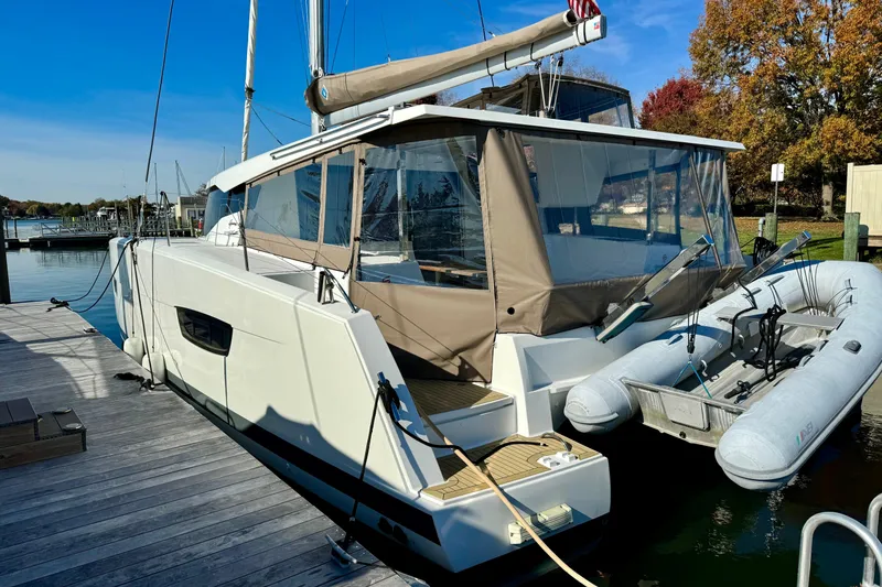 The Image of 2017 Fountaine Pajot Lucia 40 catamaran docked with inflatable dinghy attached. - 0