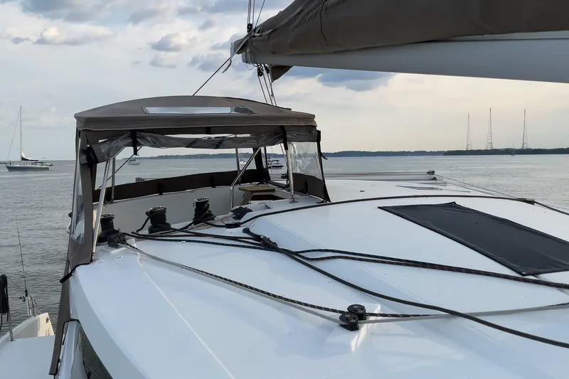 Slide: The Image of 2017 Fountaine Pajot Lucia 40 catamaran on calm waters, featuring sleek deck design. - 14