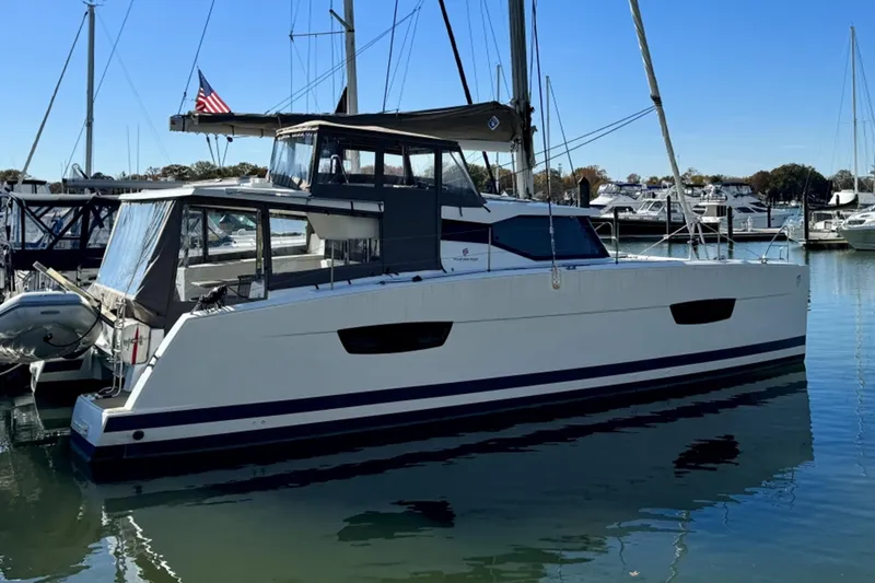 Slide: The Image of 2017 Fountaine Pajot Lucia 40 catamaran docked in a marina, side view. - 18