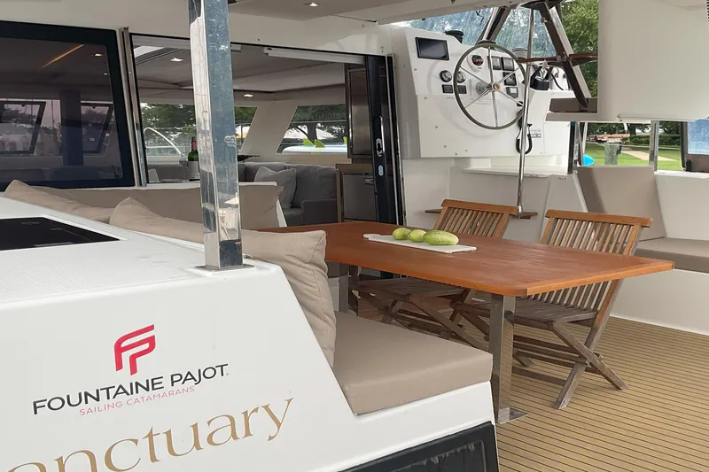 Slide: The Image of 2017 Fountaine Pajot Lucia 40 catamaran with elegant outdoor seating and helm station. - 2