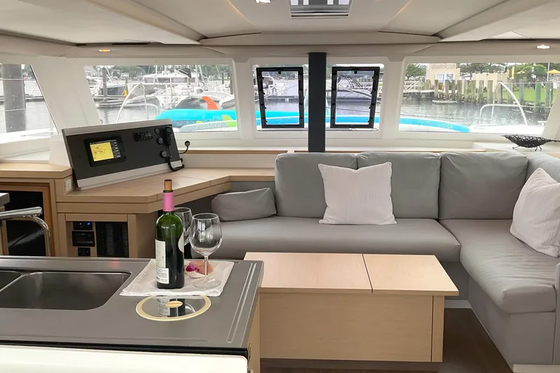 Slide: The Image of Luxurious interior of 2017 Fountaine Pajot Lucia 40 catamaran with cozy seating and wine setup. - 4