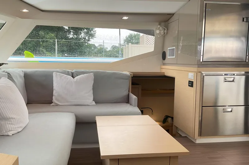 Slide: The Image of Interior of 2017 Fountaine Pajot Lucia 40 catamaran, featuring modern seating and stainless steel appliances. - 5