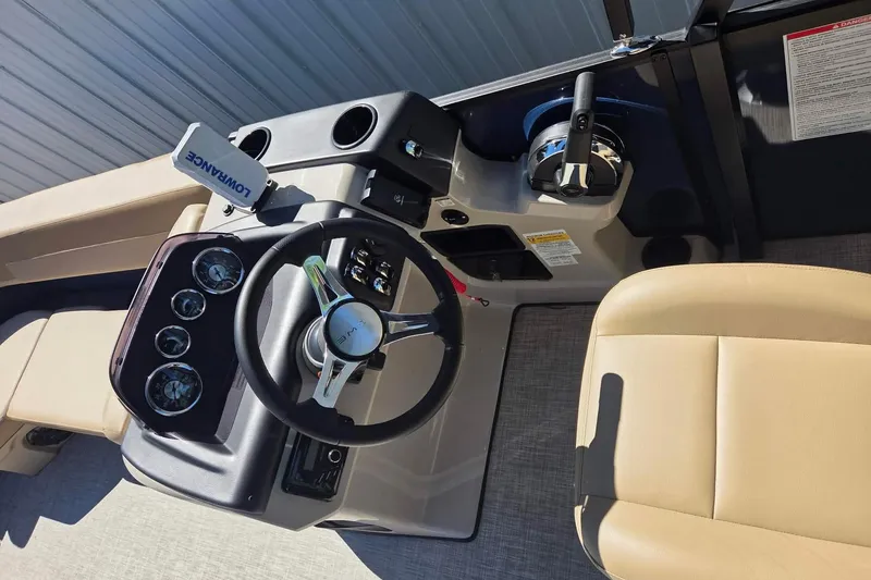Slide: The Image of Interior view of 2025 Lowe SS 210 WT boat dashboard and steering wheel. - 11