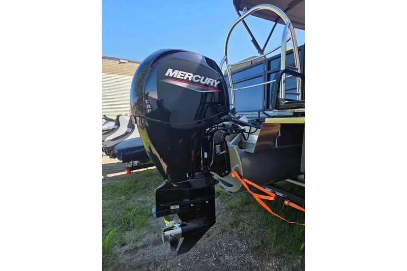 Slide: The Image of 2025 Lowe SS 210 WT boat with Mercury outboard motor, parked outdoors. - 13