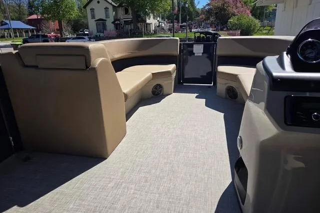Slide: The Image of 2025 Lowe SS 210 WT pontoon boat interior with beige seating and spacious layout. - 7