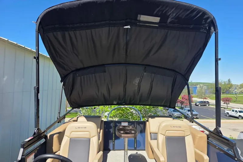 Slide: The Image of 2025 Lowe SS 210 WT boat interior with canopy and seating. - 8