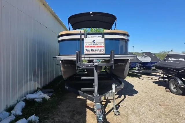 Slide: The Image of 2025 Lowe SS 210 WT pontoon boat on trailer, displayed outdoors. - 9