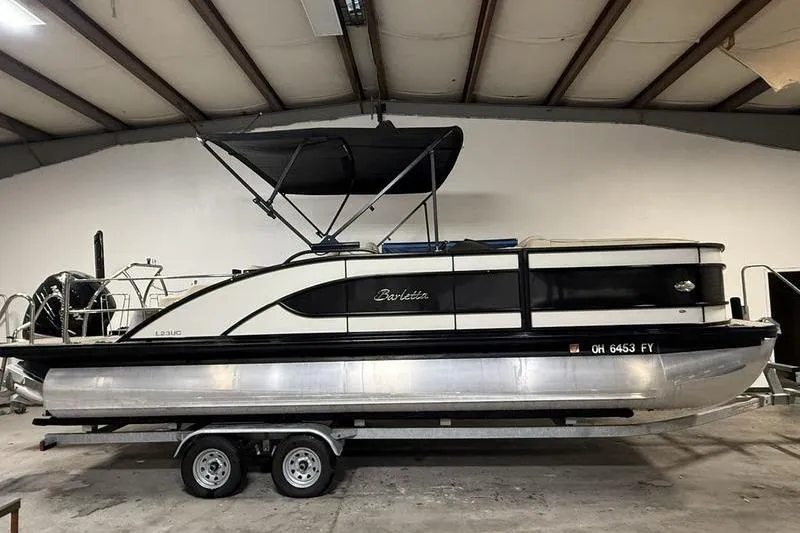 The Image of 2020 Barletta L23UC pontoon boat on trailer in indoor storage facility. - 0