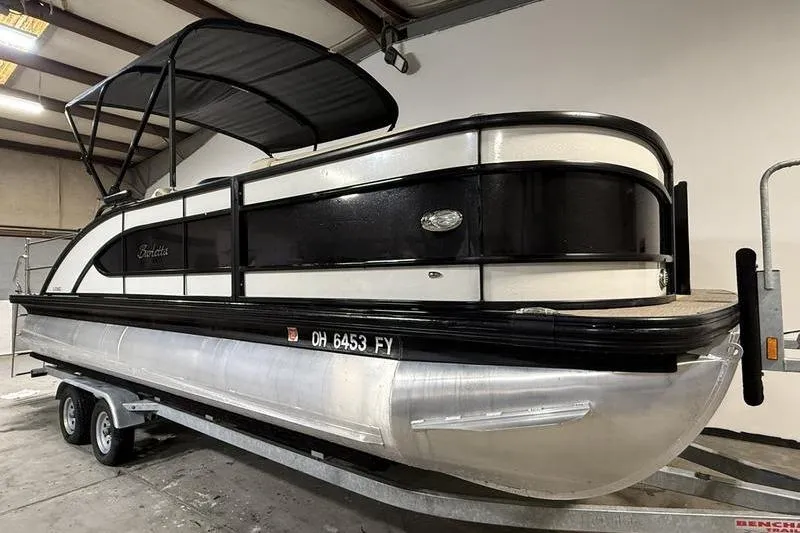 Slide: The Image of 2020 Barletta L23UC pontoon boat on trailer in indoor storage. - 1