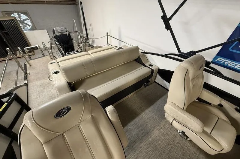 Slide: The Image of Interior of 2020 Barletta L23UC pontoon boat with beige seating and helm chair. - 10