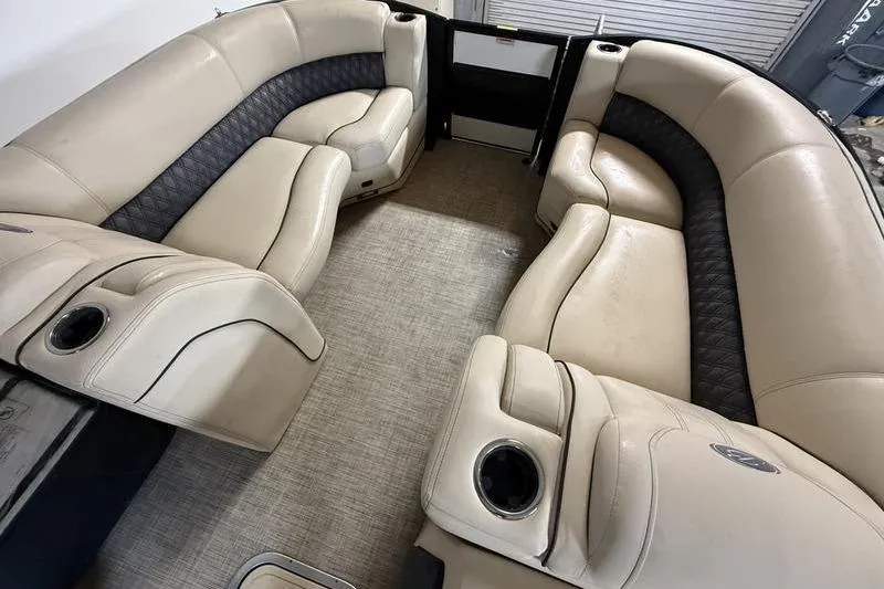 Slide: The Image of Luxurious seating inside a 2020 Barletta L23UC pontoon boat, featuring beige upholstery. - 13