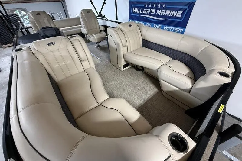 Slide: The Image of 2020 Barletta L23UC pontoon boat interior with luxurious beige seating and cup holders. - 14