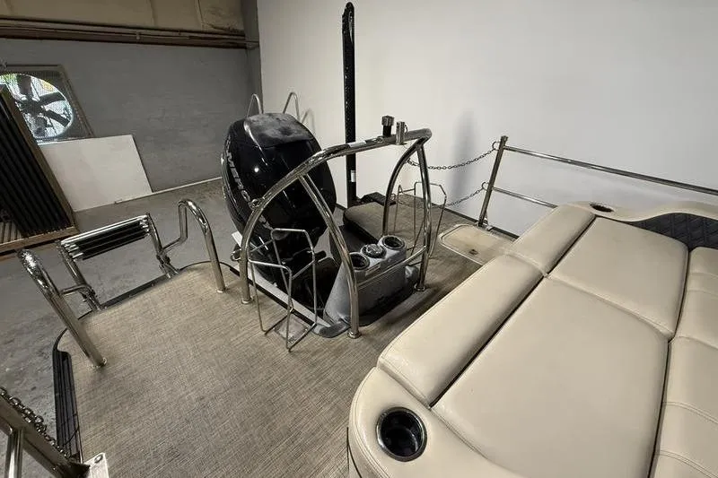 Slide: The Image of 2020 Barletta L23UC pontoon boat interior with seating and motor. - 4