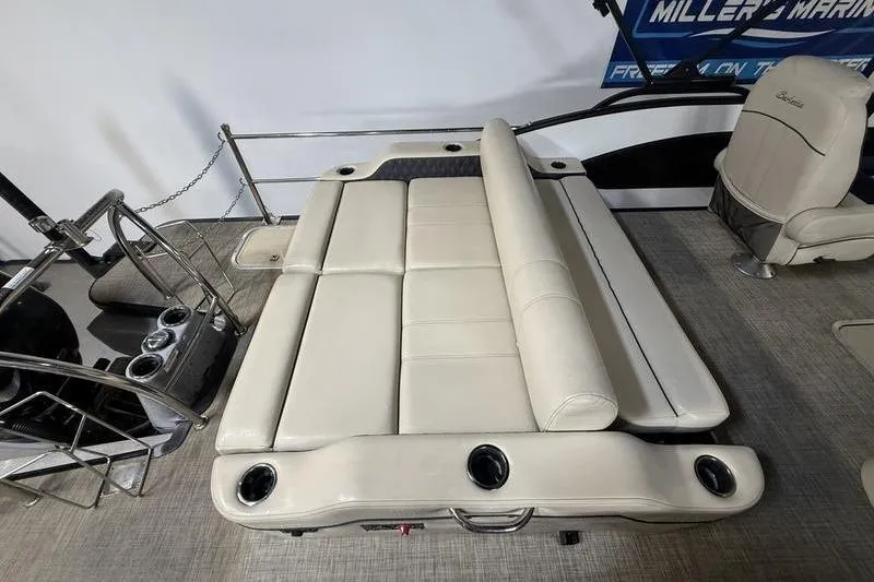Slide: The Image of 2020 Barletta L23UC boat interior with beige seating and cup holders. - 5