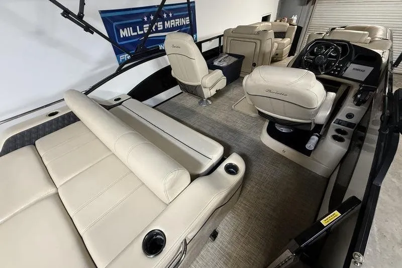 Slide: The Image of 2020 Barletta L23UC pontoon boat interior with beige seating and modern dashboard. - 6
