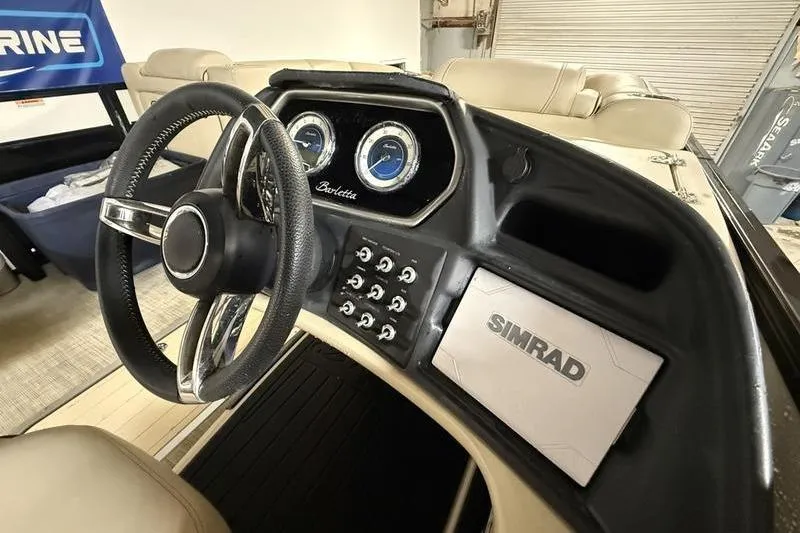 Slide: The Image of 2020 Barletta L23UC boat dashboard with steering wheel and Simrad navigation system. - 7