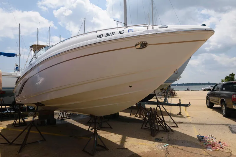 Slide: The Image of 2004 Chaparral 260 SSi boat on stands at harbor. - 1