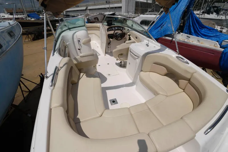 Slide: The Image of Interior view of a 2004 Chaparral 260 SSi boat with beige seating. - 2