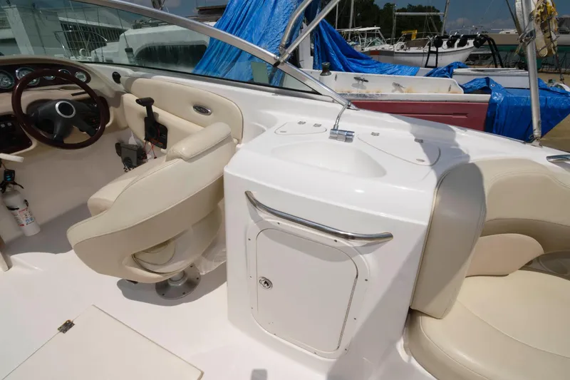 Slide: The Image of Interior of a 2004 Chaparral 260 SSi boat with beige seating. - 8