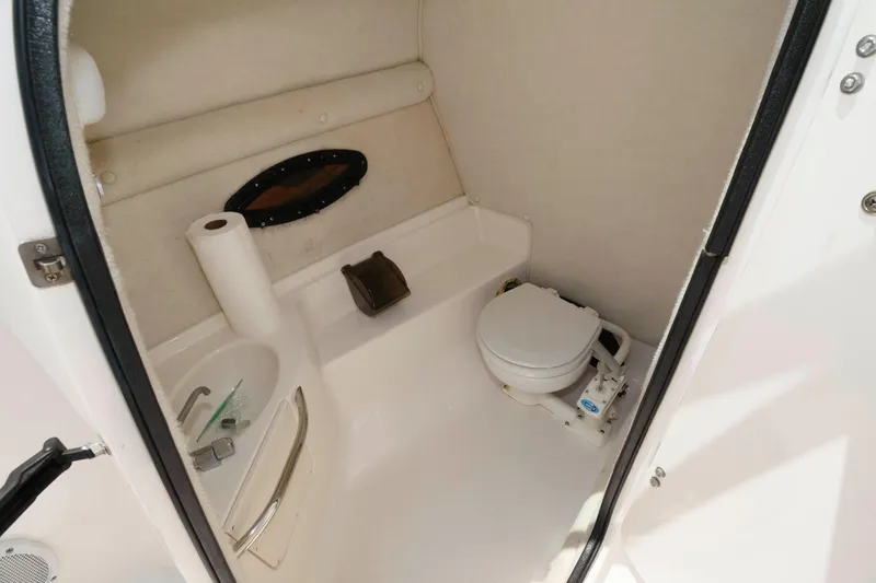 Slide: The Image of Interior of 2004 Chaparral 260 SSi featuring toilet and sink. - 9