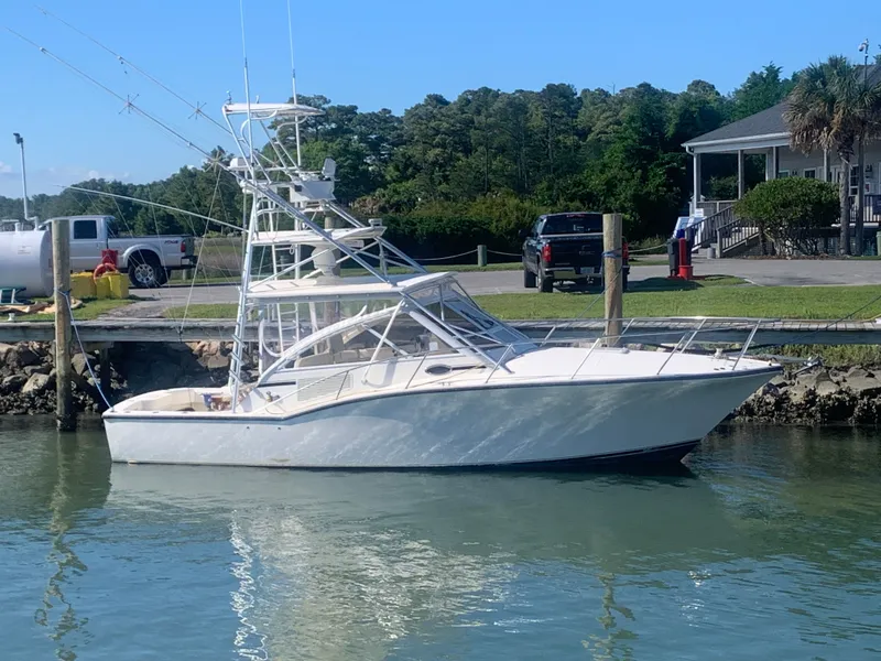 The Image of 2003 Carolina Classic Express boat docked at harbor. - 0